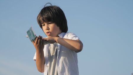 Cute boy throwing money euro banknotes.の写真素材