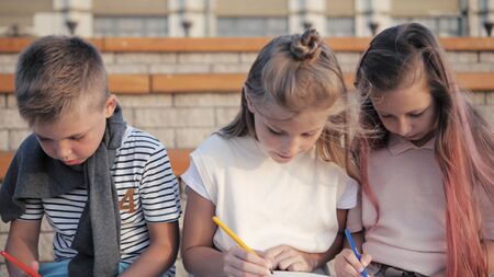 Cute kids doing artwork outdoors.の写真素材