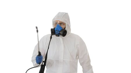 Virologist in protective uniform walking and disinfecting the area on white background.の写真素材