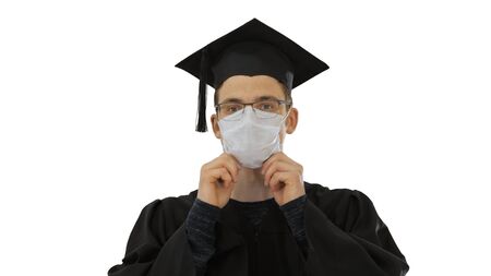 Graduation student in medical mask on white background.の写真素材