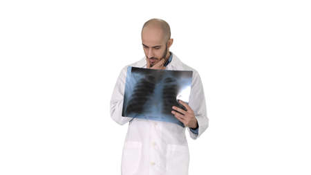 Doctor radiologist looking at x-ray scan walking on white background.
