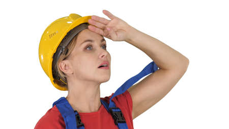 Engineer construction worker woman fascinated by the scale of construction on white background.