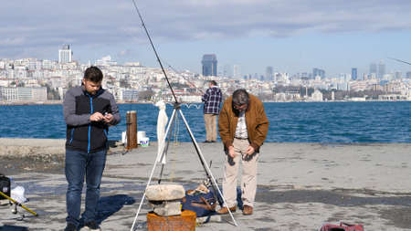 Istanbul, Turkey - January 10, 2017: People who fish on the Bosphorus in Istanbul.
