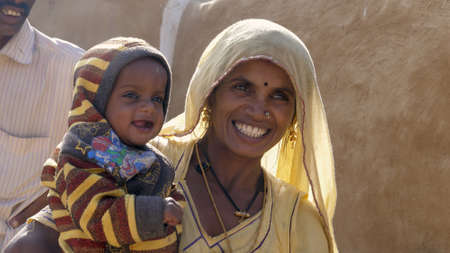 Jaisalmer, India - December 20, 2017: mother with a child smiling.