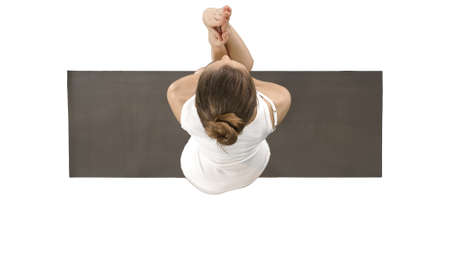 Attractive girl standing in the balancing yoga pose Garudasana Young woman in the Eagle yoga pose on...