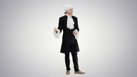 Man in 18th century camisole and wig doing welcoming gesture onの写真素材