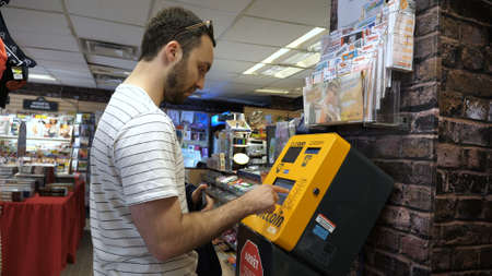 Montreal, Quebec, Canada - 25 June, 2018: Bitcoin machine or bank. Buying and selling bitcoins, one of new era cryptocurrency. Business mans hand.のeditorial素材