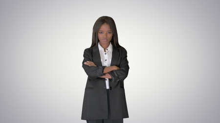 Confident african american businesswoman with crossed arms on grの写真素材