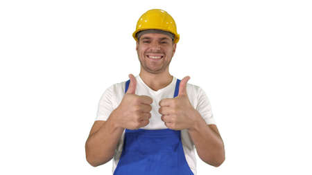 Amazed builder contractor is showing thumbs up Happy about result of his work on white background.の写真素材