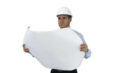 Engineer checking construction plan with what is built on white background.