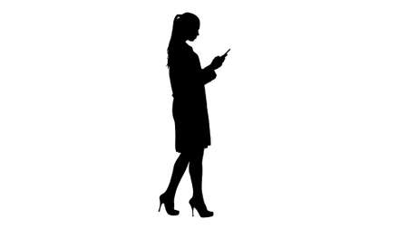 Silhouette Cheerful cute young woman doctor typing text on phoneの写真素材