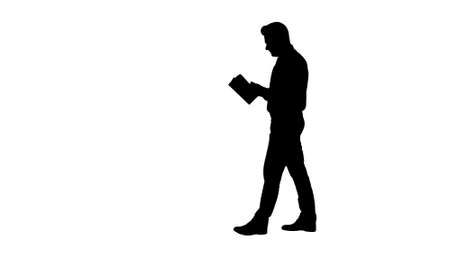 Silhouette Young confused man trying to read smart book misunderstanding content while walking.の写真素材