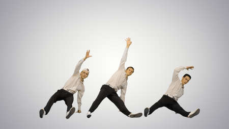 Three guys doing break dance in synch looking at camera gradient background