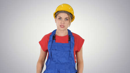 Woman in construction outfit talking to camera while walking on