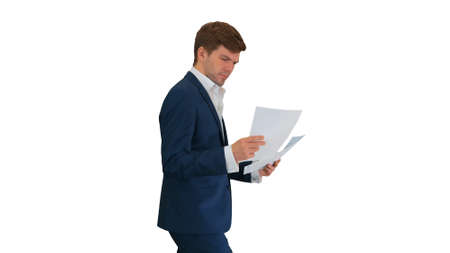 Serious Businessman reading documents or report while walking onの写真素材