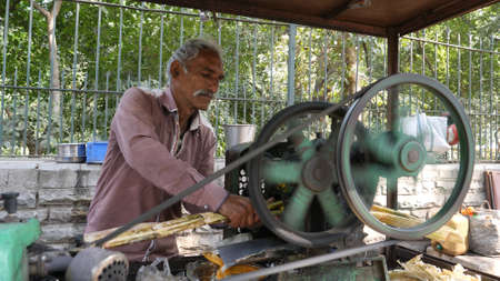 Jaisalmer, India - December 20, 2017: Man makes juice from sugarcane.のeditorial素材