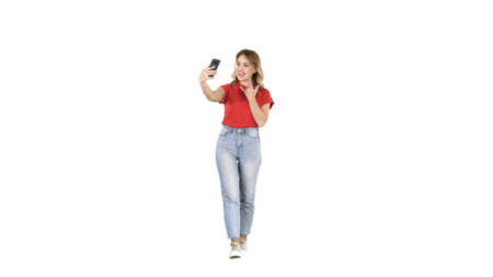 Cute sexy girl with blond curly hair walking and making selfieの写真素材