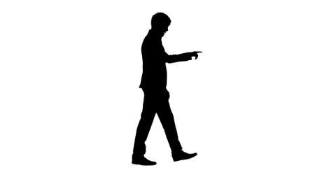 Silhouette Businessman walking and explaining something to camerの写真素材