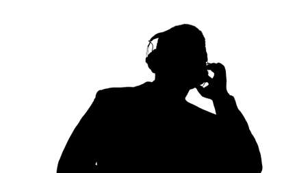 Silhouette Black businessman dancing to music in headphones.の写真素材