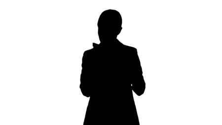 Silhouette Serious Businesswoman giving tasks talking on her phoの写真素材