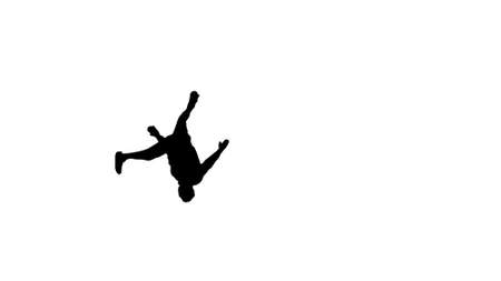 Silhouette Young man in white shirt doing back flip looking at cの写真素材