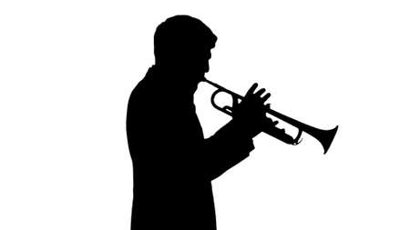 Silhouette Young man in suit playing a trumpet while walking.の写真素材