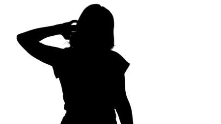 Silhouette Beautiful happy young woman walking and stretching inの写真素材