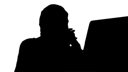 Silhouette Woman watching videos on computer and laughing.の写真素材