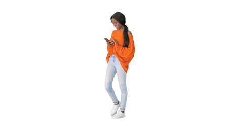 Pretty african american woman in bright jumper dictating messageの写真素材