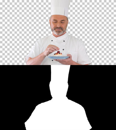 Chef putting cherry on top of the cake before serving it Icing oの写真素材