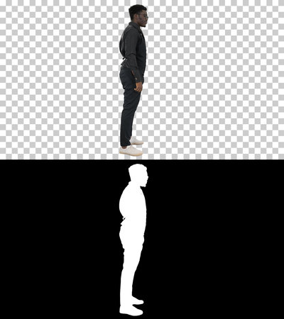 Young African American businessman in glasses standing and pulliの写真素材