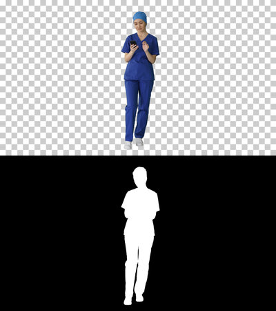 Thinking female doctor using her smartphone, Alpha Channel withの写真素材