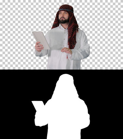 Sheikh using digital tablet and walking, Alpha Channel with Silhの写真素材