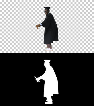 Excited african american male student in graduation robe dancingの写真素材