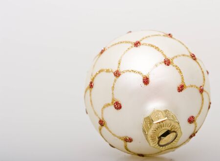 white christmas ball with golden decoration の写真素材