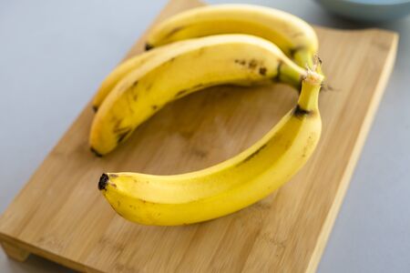 banana bunch close up on the kitchen tableの写真素材