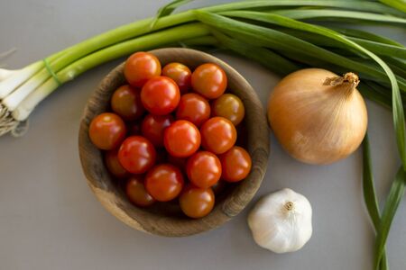 cherries tomatoes green onion and garlicの写真素材