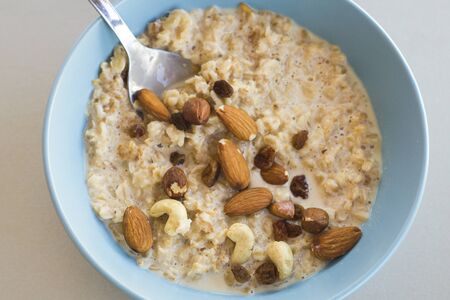 oat meal bowl with nuts breakfastの写真素材