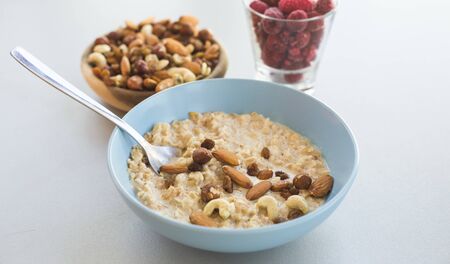 oat meal bowl with nuts breakfastの写真素材