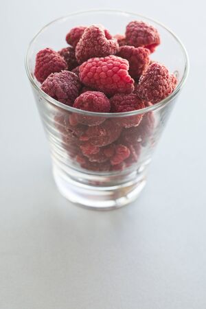 frozen raspberries in glass close upの写真素材