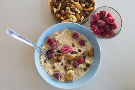 oatmeal with nuts and raspberriesの写真素材