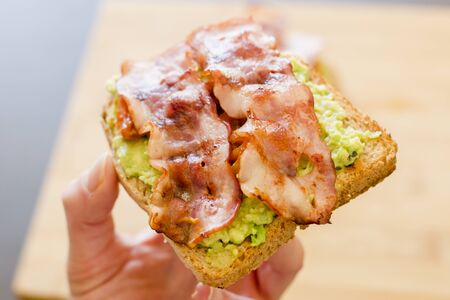 avocado toast with cherries tomatoes and baconの写真素材