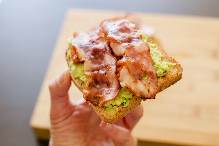 avocado toast with cherries tomatoes and baconの写真素材
