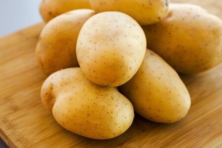 close up potatoes on kitchen tableの写真素材