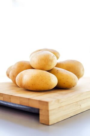 close up potatoes on kitchen tableの写真素材