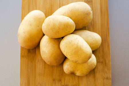 close up potatoes on kitchen tableの写真素材