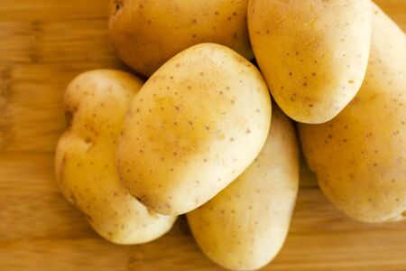 close up potatoes on kitchen tableの写真素材