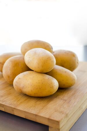 close up potatoes on kitchen tableの写真素材