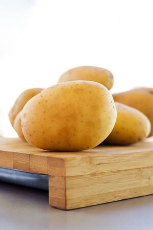 close up potatoes on kitchen tableの写真素材