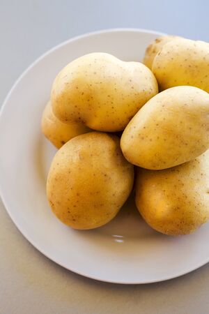 close up potatoes on kitchen tableの写真素材